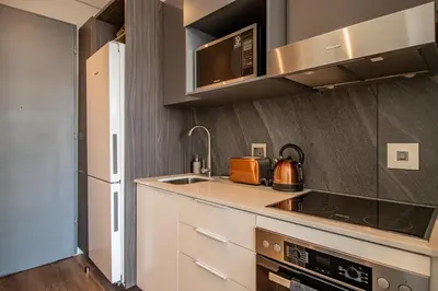 a kitchen with a sink and a stove at Menlyn Maine Unit 1420 in Pretoria