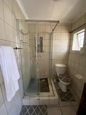 a bathroom with a shower and a toilet at HomeSweetHome City Apartment in Nelspruit