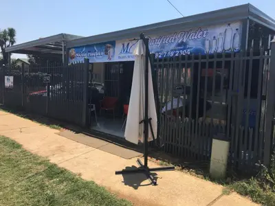 an umbrella sitting in front of a building at Mighty7 Bed and Breakfast Guesthouse in Pretoria