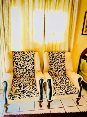 a living room with two chairs and a window at Mighty7 Bed and Breakfast Guesthouse in Pretoria