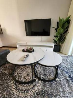 a living room with two tables and a flat screen tv at 56 - Elegant 2 bed apartment next to Gautrain Centurion in Centurion
