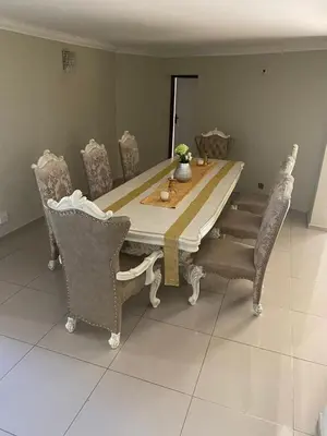a dining room table with chairs and a table and a table and chairsktop at MOK villa holiday home in Hazyview
