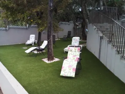a patio with chairs and a table and a tree at MOK villa holiday home in Hazyview
