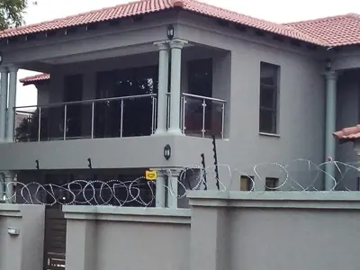 a house with a fence on top of it at MOK villa holiday home in Hazyview