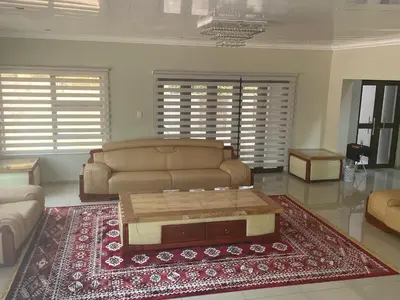 a living room with a couch and a coffee table at MOK villa holiday home in Hazyview