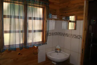 a bathroom with a sink and a window at Fern Cottage in Louis Trichardt