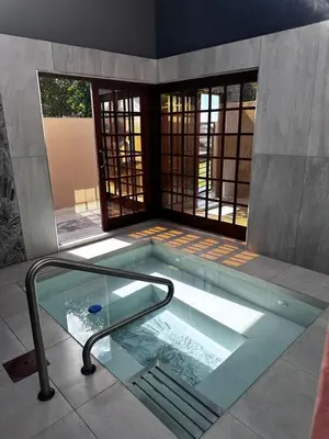 a swimming pool with a glass floor in a house at Banabaka spa and venue in White River