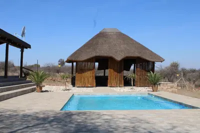 a gazebo with a pool in front of it at Sharon Lodge in Hammanskraal