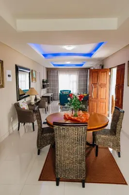 a dining room with a table and chairs at Gosheni Villas in White River