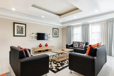 a living room with two chairs and a table at Gosheni Villas in White River