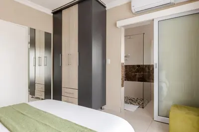 a bedroom with a bed and a walk in closet at Gosheni Villas in White River