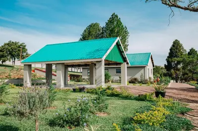 a house with a green roof at Gosheni Villas in White River