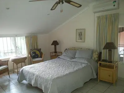a bedroom with a large bed and a window at Boschfontein Guest Farm in Thabazimbi