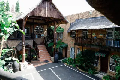 a house with a gambrel roof and a courtyard at Big 5 Guest House Witbank in Witbank