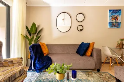 a living room with a couch and a table at 82 NOLE 2bed 2 bath apartment in Midrand