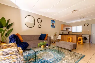 a living room with a couch and a table at 82 NOLE 2bed 2 bath apartment in Midrand