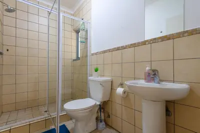 a bathroom with a toilet and a sink at 82 NOLE 2bed 2 bath apartment in Midrand