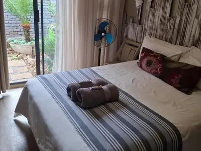 a stuffed animal sitting on top of a bed at SomethingElz@Grace in Pretoria