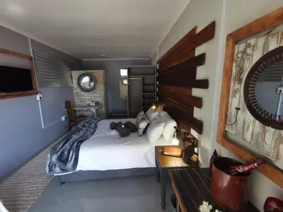 a bedroom with a bed with a teddy bear on it at SomethingElz@Grace in Pretoria