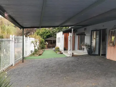 a patio of a house with a white fence at SomethingElz@Grace in Pretoria