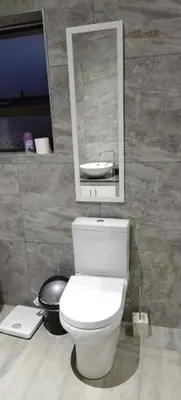 a bathroom with a white toilet and a sink at Cheers in Evander