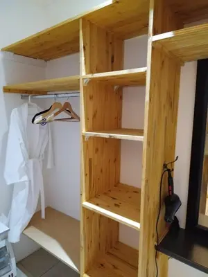a wooden book shelf in a closet at Cheers in Evander