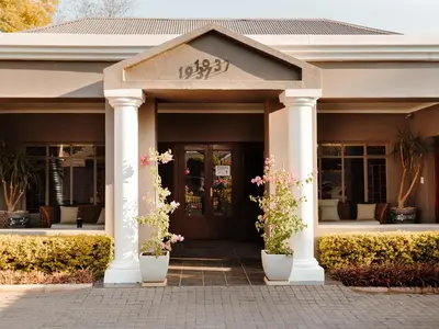 a front door of a house with potted plants at 37 On Anderson in Pretoria