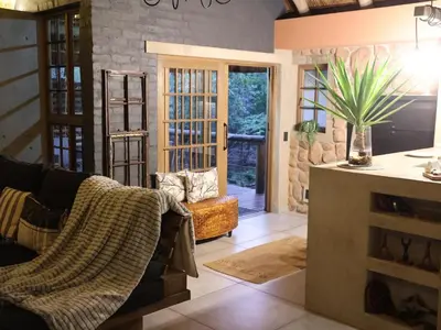 a living room with a couch and a table at Monkey Thorn in Roodeplaat