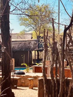 a resort with a swimming pool and a building at Nyala Luxury Safari Tents in Marloth Park