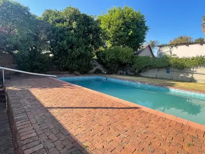 a swimming pool on top of a red brickicked yard at Tranquil Haven in Kempton Park