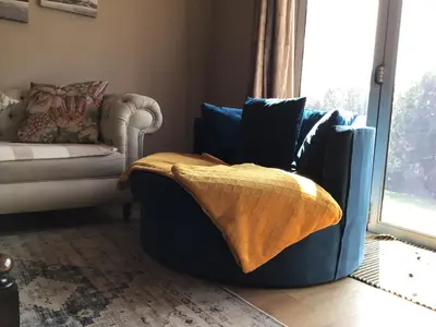 a living room with a blue couch with pillows at Tranquil Haven in Kempton Park