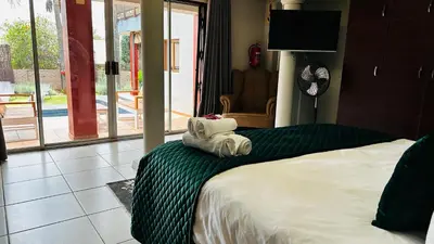 a hotel room with a bed with towels on it at Aspen Guest House NO LOADSHEDDING in Centurion