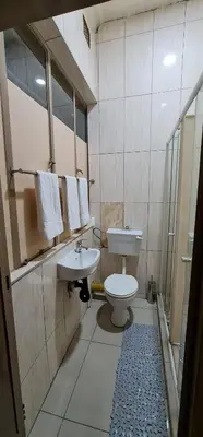 a bathroom with a toilet and a sink at My House Guest House in Pretoria