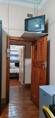 a room with a tv on top of a door at My House Guest House in Pretoria