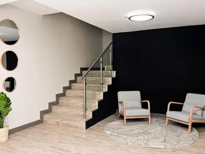 a lobby with two chairs and a staircase at Sou House in Louis Trichardt