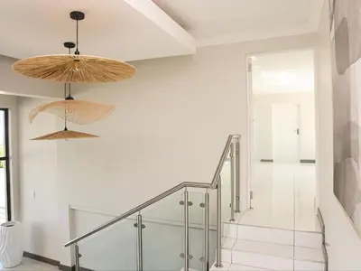 a staircase in a house with white walls at Sou House in Louis Trichardt