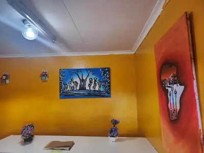 a yellow room with a table and a painting on the wall at WAMPEX GUEST HOUSE IN NORTHAM CBD 239 COAL STREET in Northam