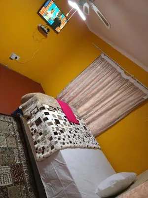 a bedroom with a bed in a yellow room at WAMPEX GUEST HOUSE IN NORTHAM CBD 239 COAL STREET in Northam