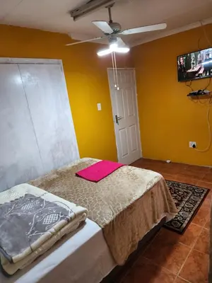 a bedroom with a bed with a pink blanket on it at WAMPEX GUEST HOUSE IN NORTHAM CBD 239 COAL STREET in Northam