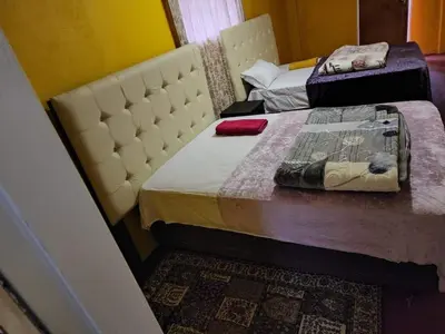 two beds in a room with a bedskirts at WAMPEX GUEST HOUSE IN NORTHAM CBD 239 COAL STREET in Northam