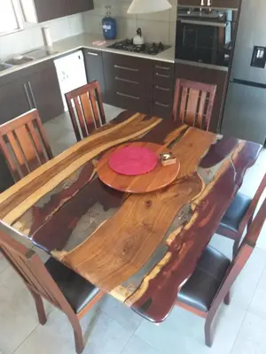 a kitchen with a wooden table with chairs around it at Bushveld Magic in Klipdrift