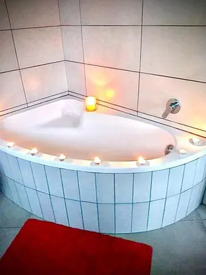 a bath tub with a candle in a bathroom at Bushveld Magic in Klipdrift
