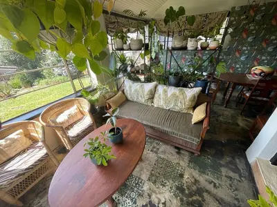 a living room with a couch and a table at A Bird Cage Stay & Cottage in Haenertsburg
