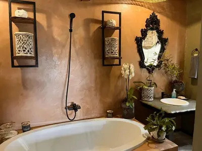 a bathroom with a large tub and a sink at A Bird Cage Stay & Cottage in Haenertsburg