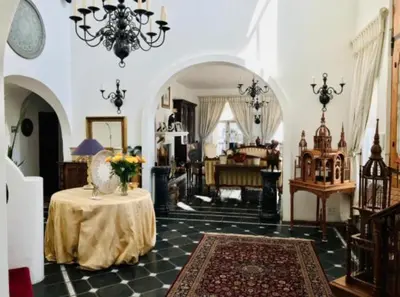 a living room with a table with a vase on it at Waterkloof Mansion Boutique Hotel in Pretoria