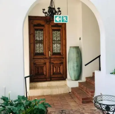 a wooden door with a vase in front of it at Waterkloof Mansion Boutique Hotel in Pretoria