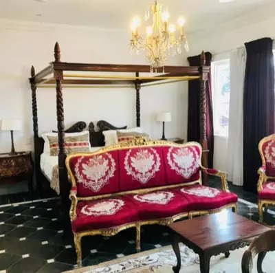 a living room with a couch and a bed at Waterkloof Mansion Boutique Hotel in Pretoria
