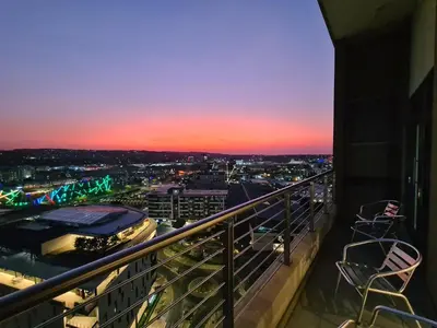 a view of a city from a balcony at sunset at Top Floor Penthouse - Overlooking Times Square Casino in Pretoria