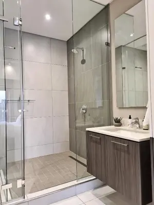 a bathroom with a glass shower and a sink at Top Floor Penthouse - Overlooking Times Square Casino in Pretoria