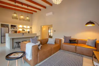 a living room with a couch and a table at Cheetah's Run in Marloth Park
